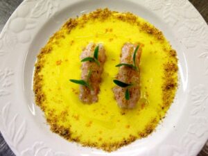 Impiattamento crema di riso allo zafferano con scampi e polvere di panettone Loison